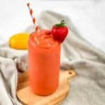 Sunrise Sunset Tropical Smoothie Cafe Copycat in a tall glass with a straw.