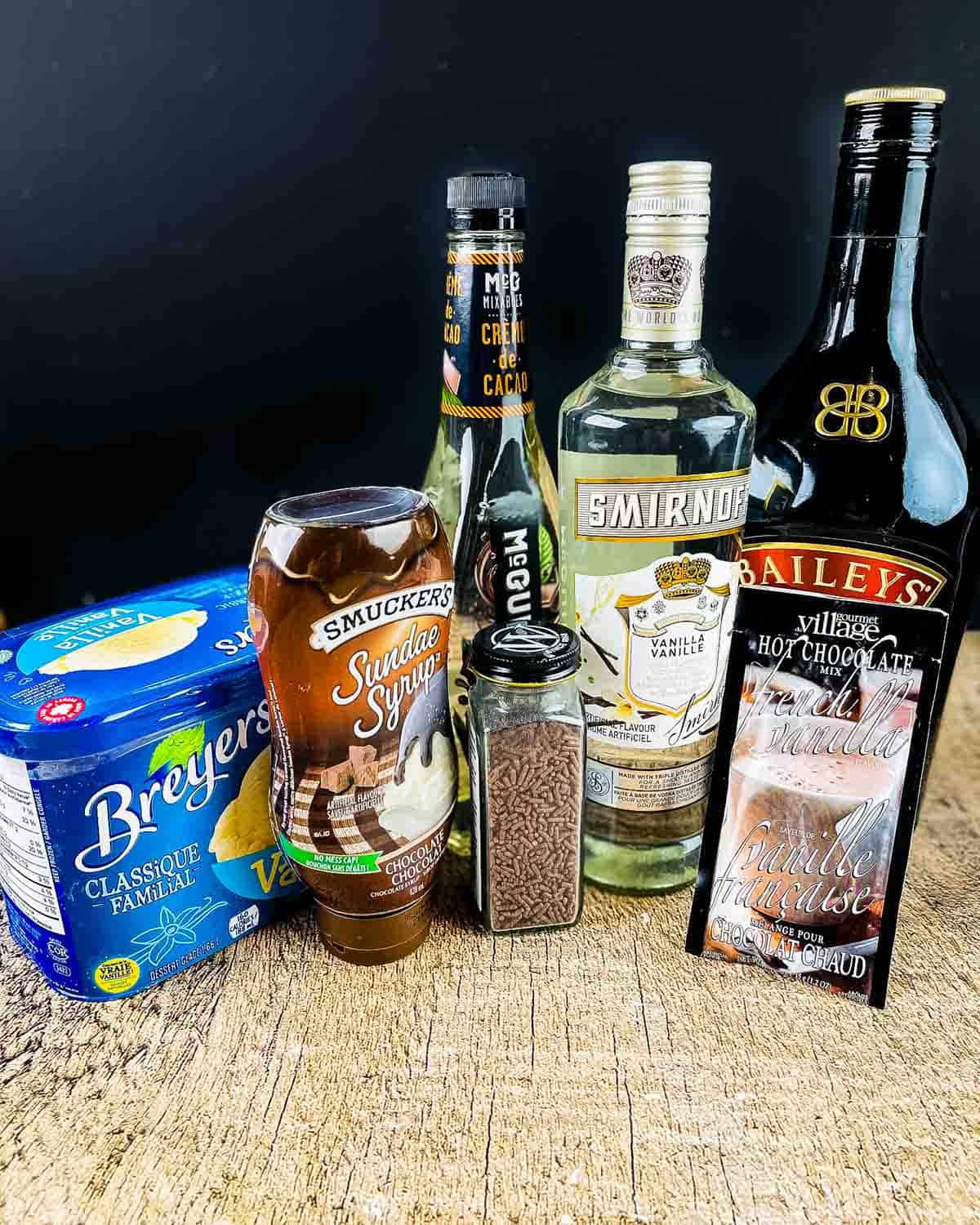 The ingredients for a dirty snowman cocktail placed on a wooden table.