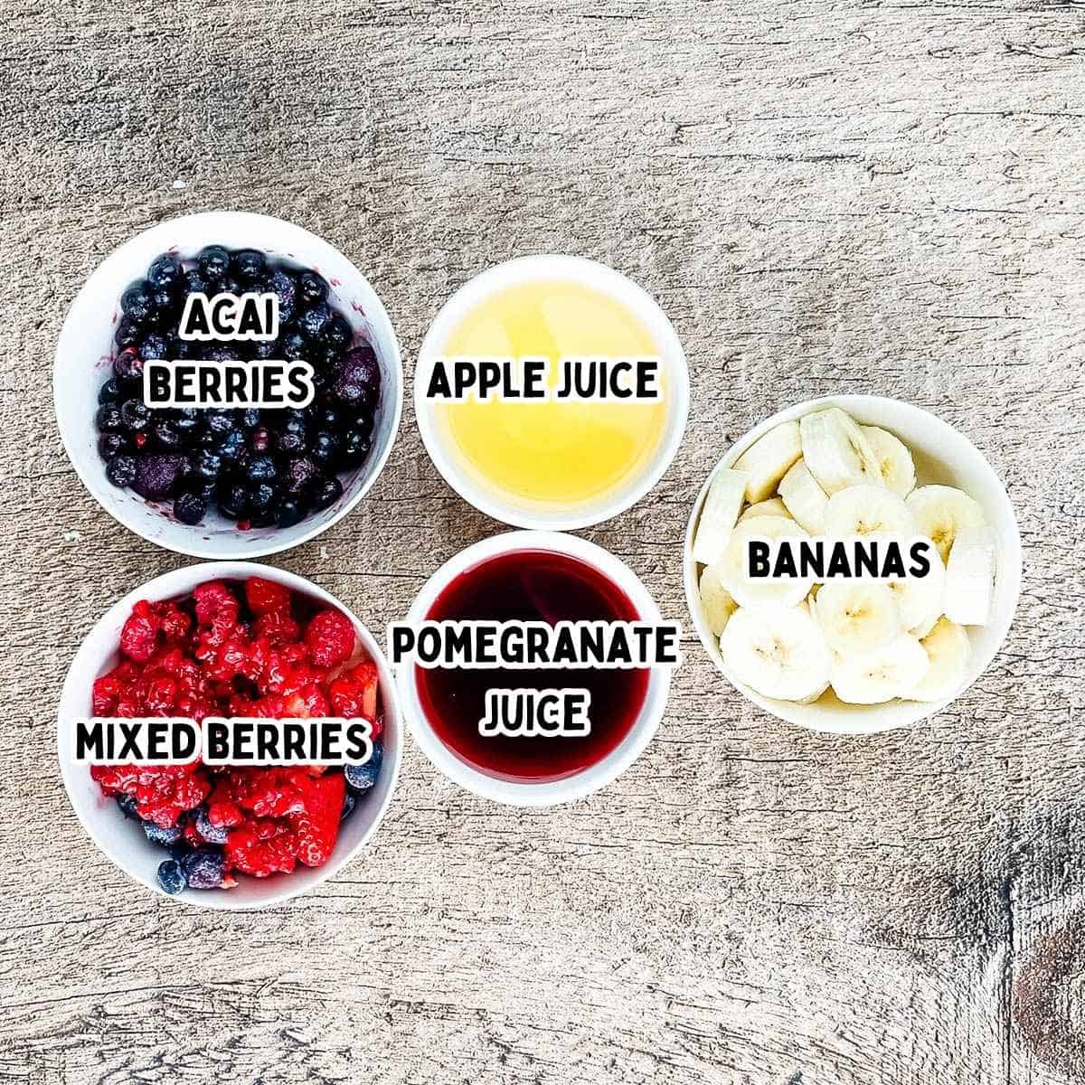 Labeled ingredients for the acai berry smoothie in small bowls.