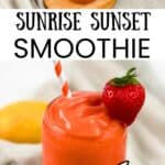 A tall glass filled with homemade sunrise sunset tropical smoothie copycat, garnished with a fresh strawberry.