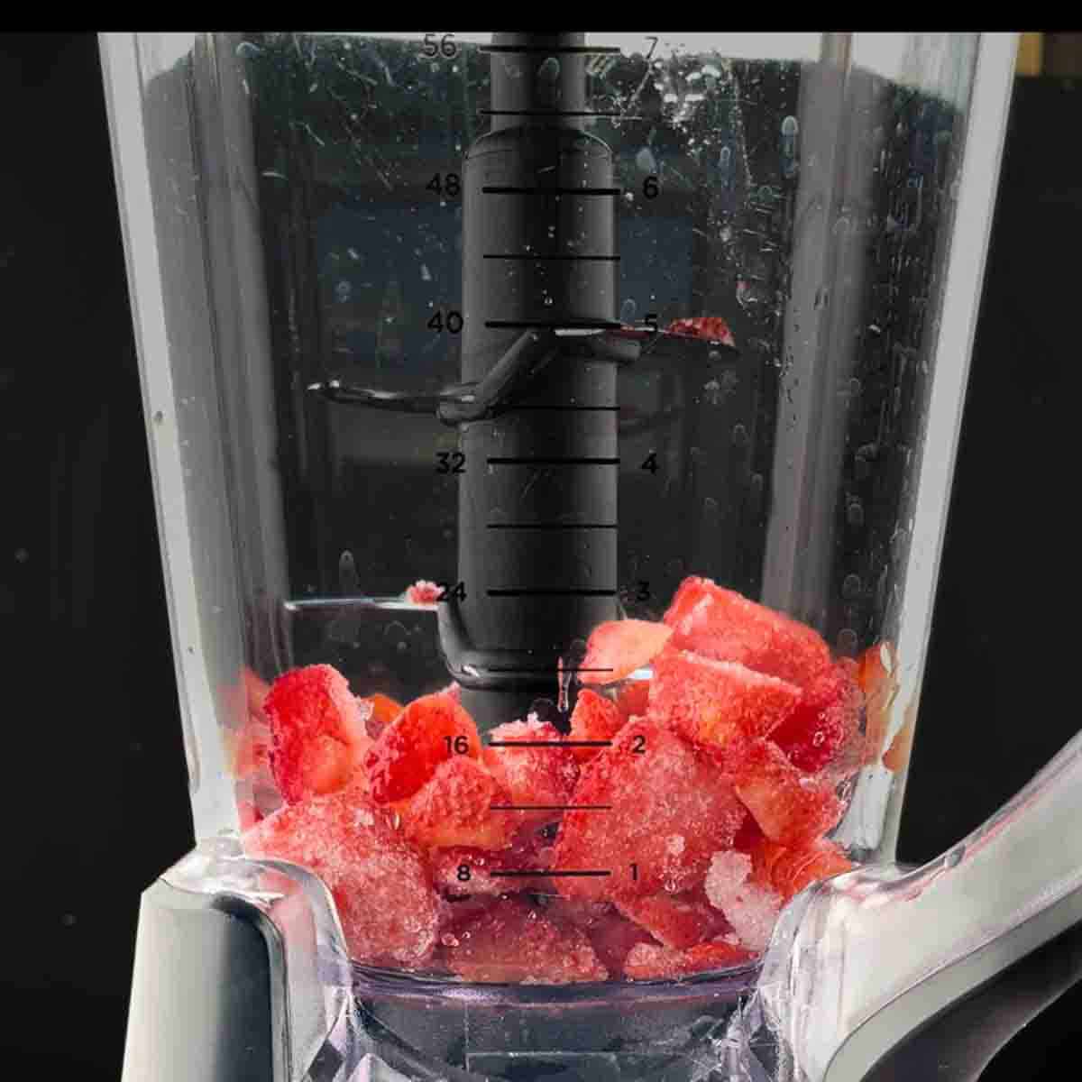 Ingredients for Bacardi strawberry daiquiri in a blender.