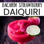 Frozen Bacardi strawberry daiquiri in a cocktail glass garnished with fresh strawberries and a lime wheel.